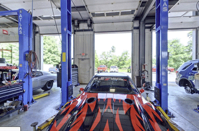 Red Car in Shop Bay